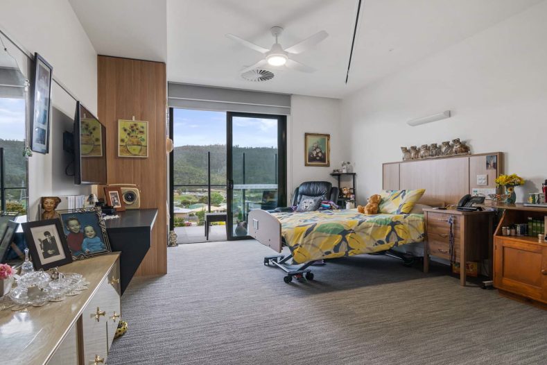 A resident's room with personal decor, images and more, as well as a valley view