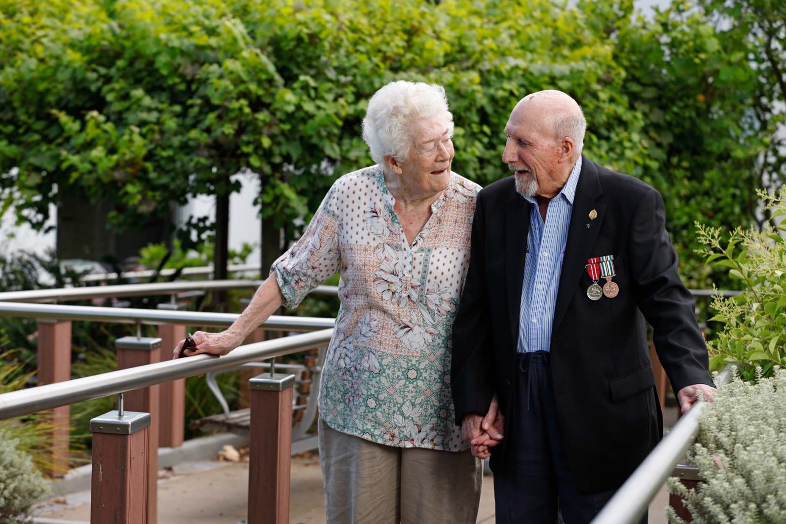 Two residents featured, who are standing in the garden