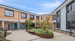 Landscaped gardens featuring walking paths, seating areas and plants.