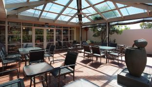 On-site cafe features an outdoor area with tables and seats.