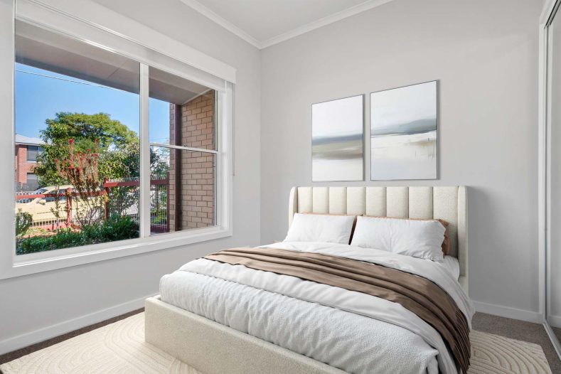 Kalkee ILU bedroom is photographed with a bed in the middle and a window on the side.