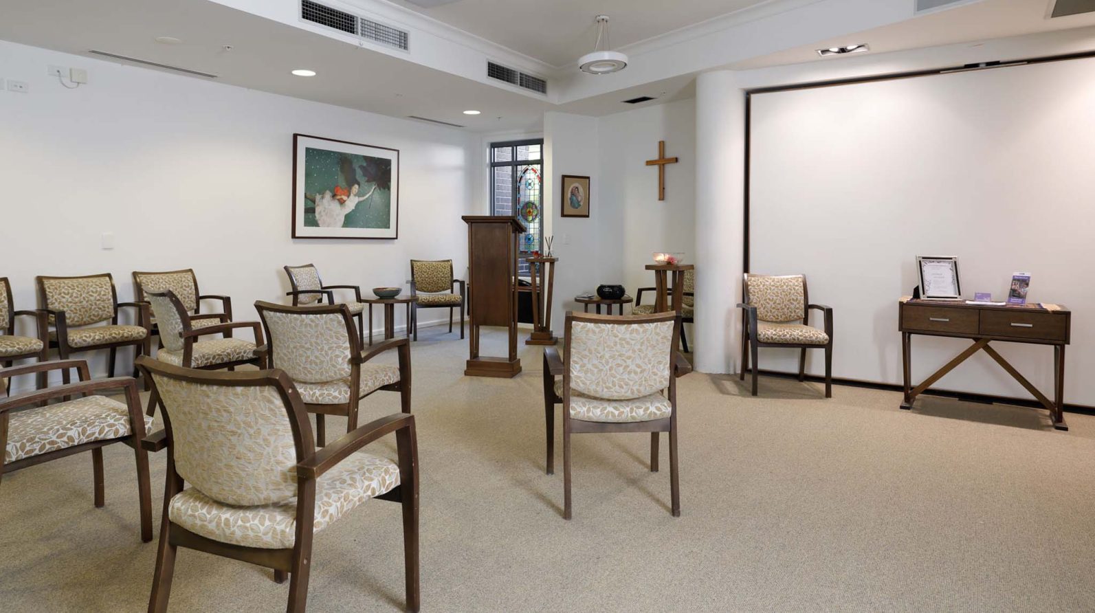 In the chapel, there are seats available and a stage.