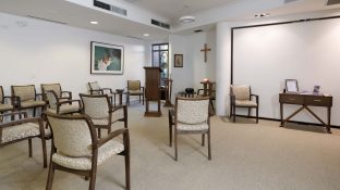 In the chapel, there are seats available and a stage.