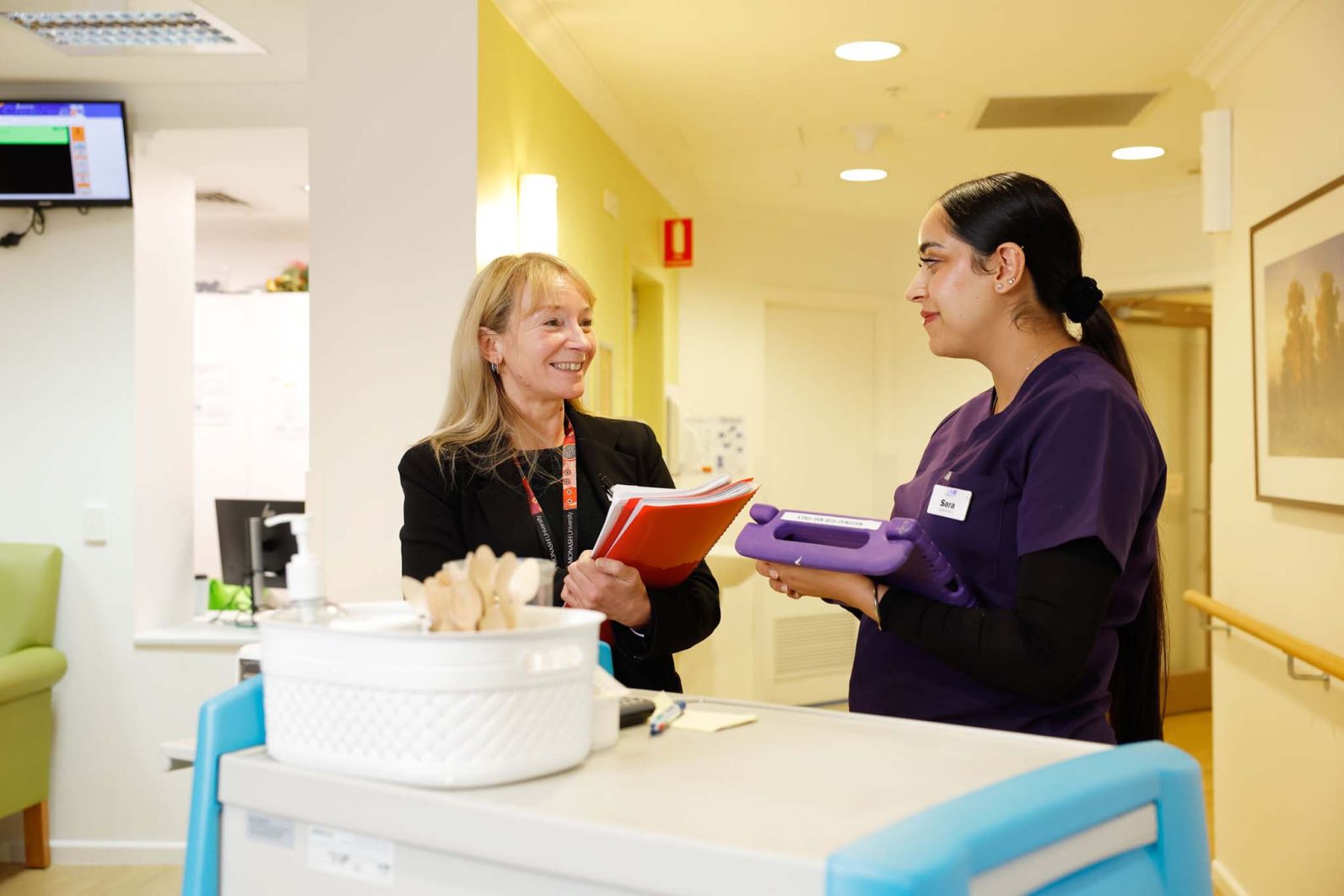 Two staff members are being photographed at Kingsville Community