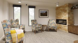 A lounge with seating area and fireplace