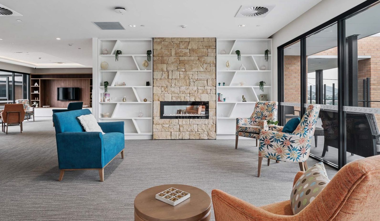 The lounge area with seats and fireplace is photographed.