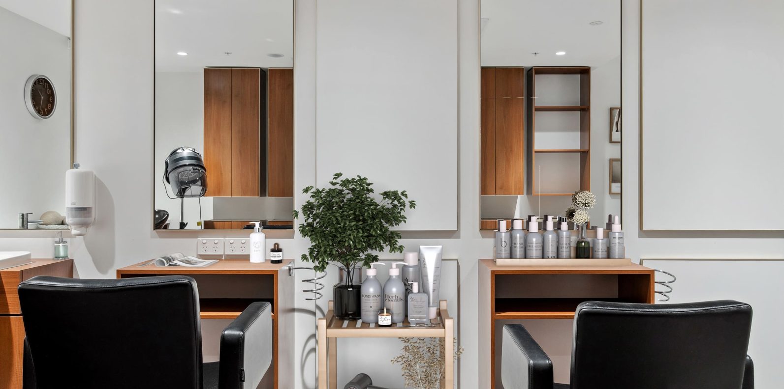 A salon with chairs and a variety of hair products is pictured.