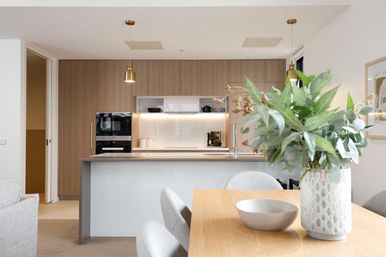 Overview of apartment living room, dining area and kitchen.