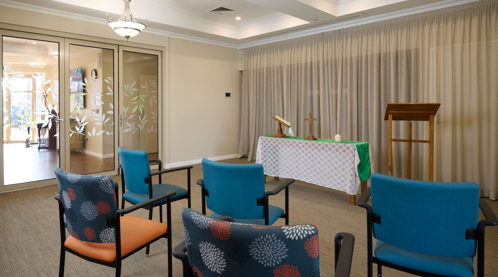 The image captures the chapel at Manor Lakes Community with seats.