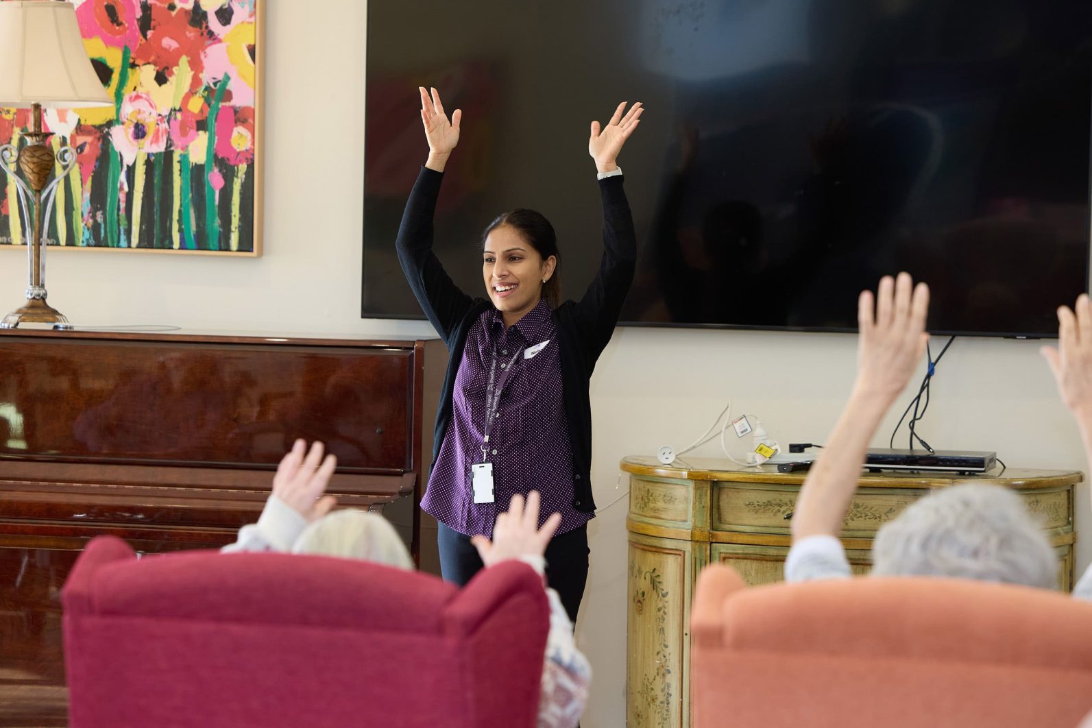 The lifestyle coordinator at Manor Lakes Community is guiding residents through activities.