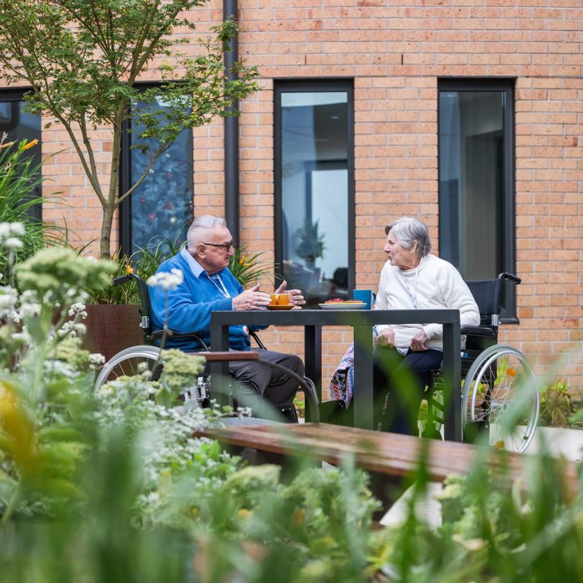 Residents pictured chatting in the gardens.