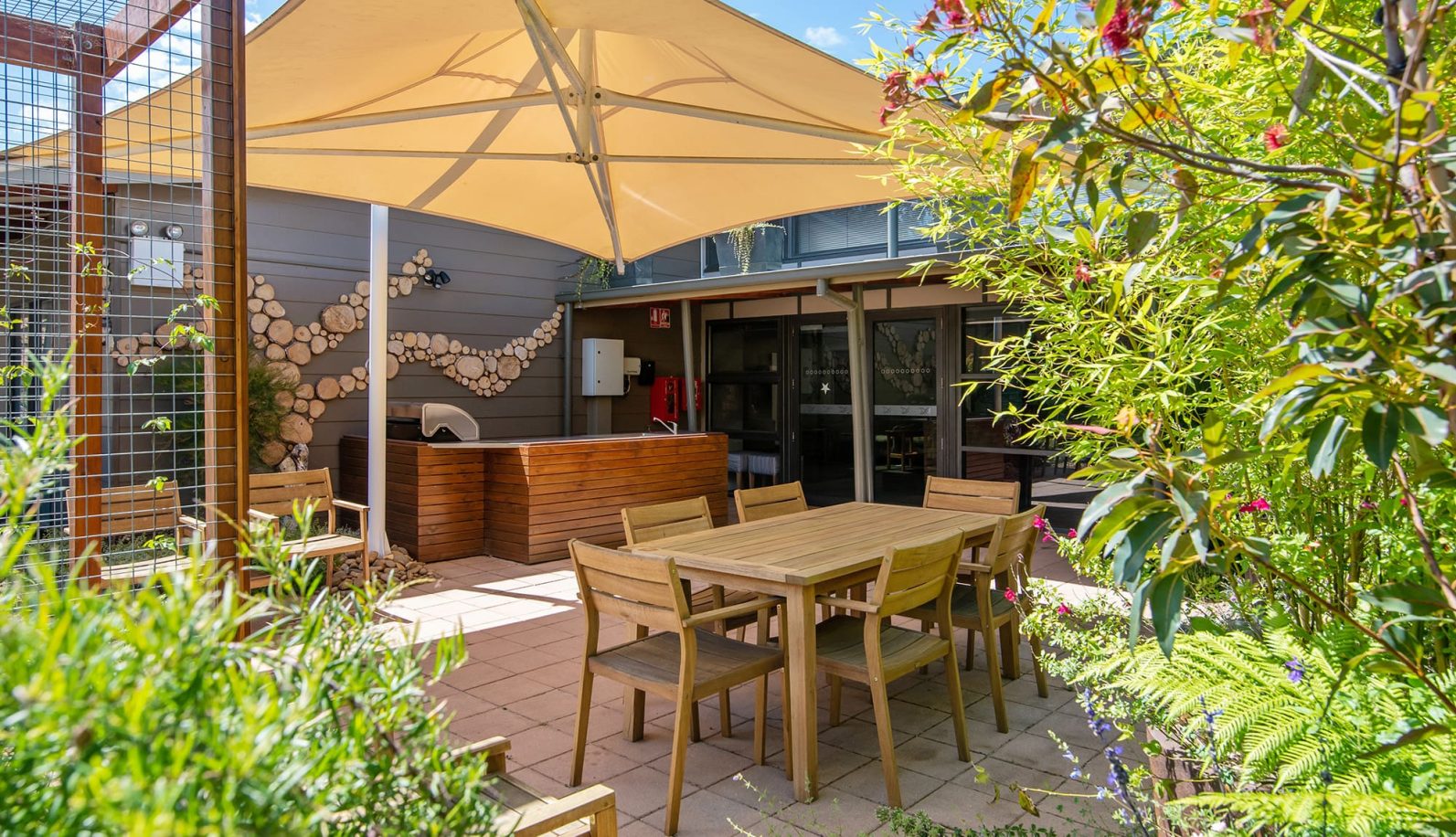 Courtyard with gazebo, outdoor seating and table.