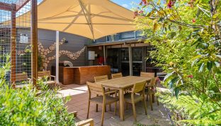 Courtyard with gazebo, outdoor seating and table.