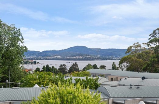 The photo features the landscape of Sandy Bay and ther Lambert Gully.