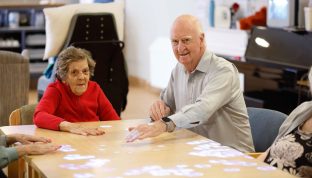 Residents are pictured playing cards togehter