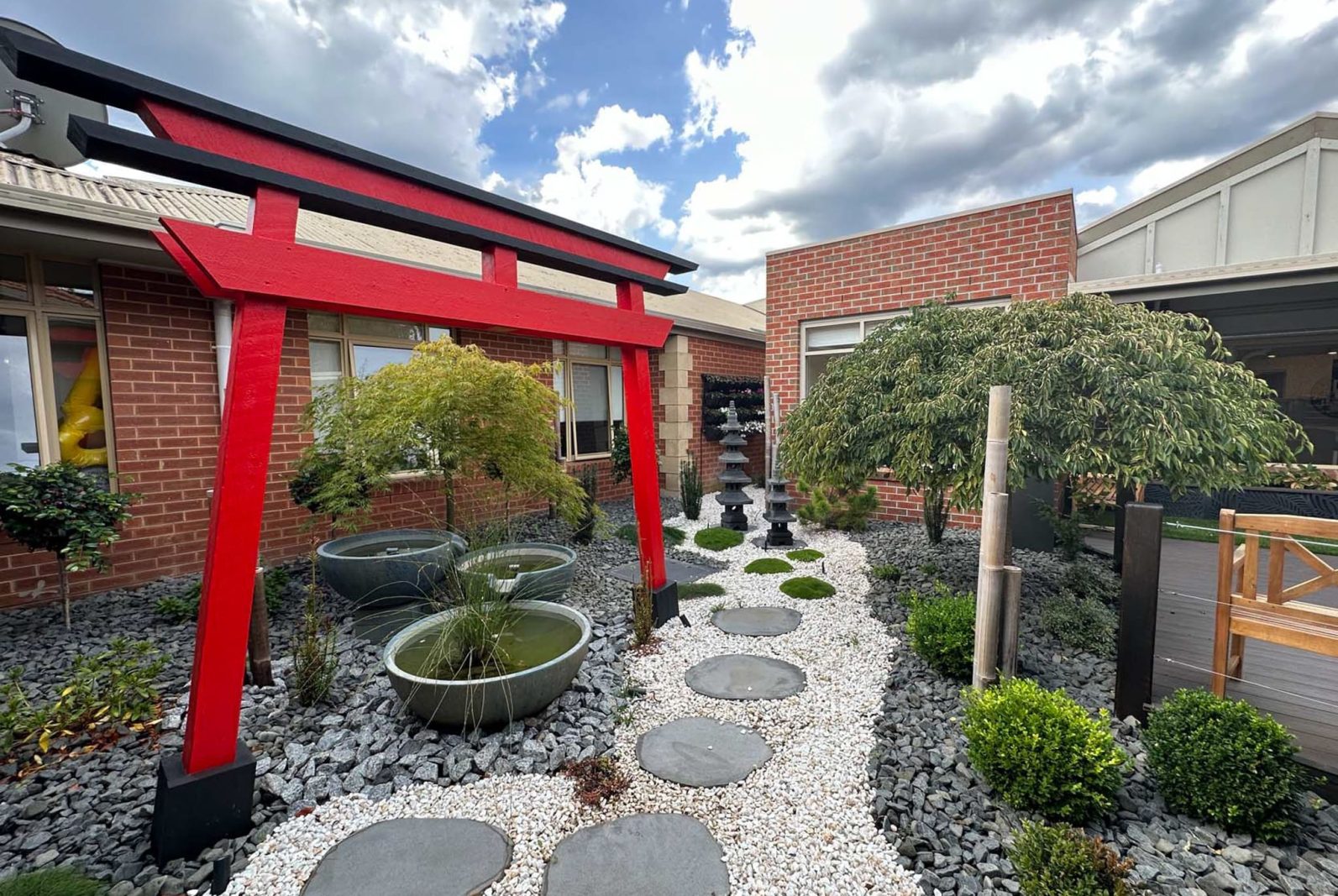 Asian garden onsite, featuring a torii gate in red, a traditional Japanese gateway