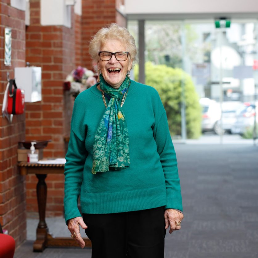 Customer is pictured smiling.