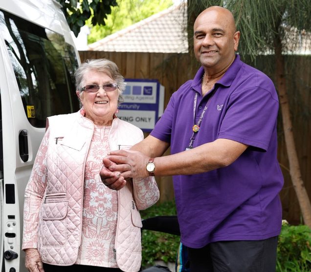 A social connections customer and staff member are pictured.