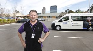 Person in carpark in front of van.