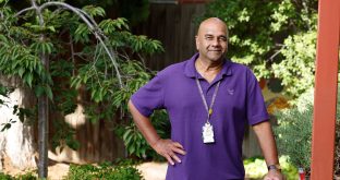 A Uniting AgeWell staff member is smiling at the camera