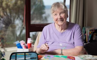 A resident is pictured painting in her room at Rosetta Community, Strathaven