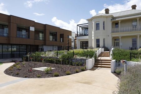 Exterior of Andrew Kerr Care Community with the home's modern facade visible alongside the historic Glenbank Mansion