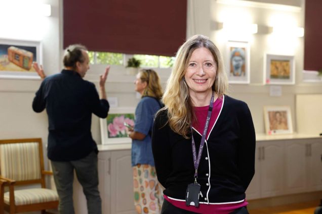 A Uniting AgeWell staff member is smiling at the camera