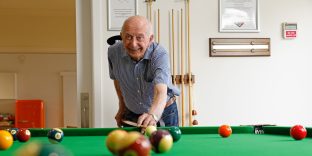 Resident playing billiards at Amarco.