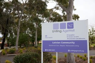 Close-up of the directional sign at the Latvian Community