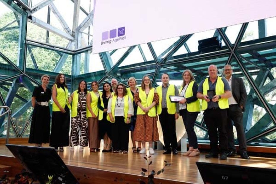 Team on stage accepting award.