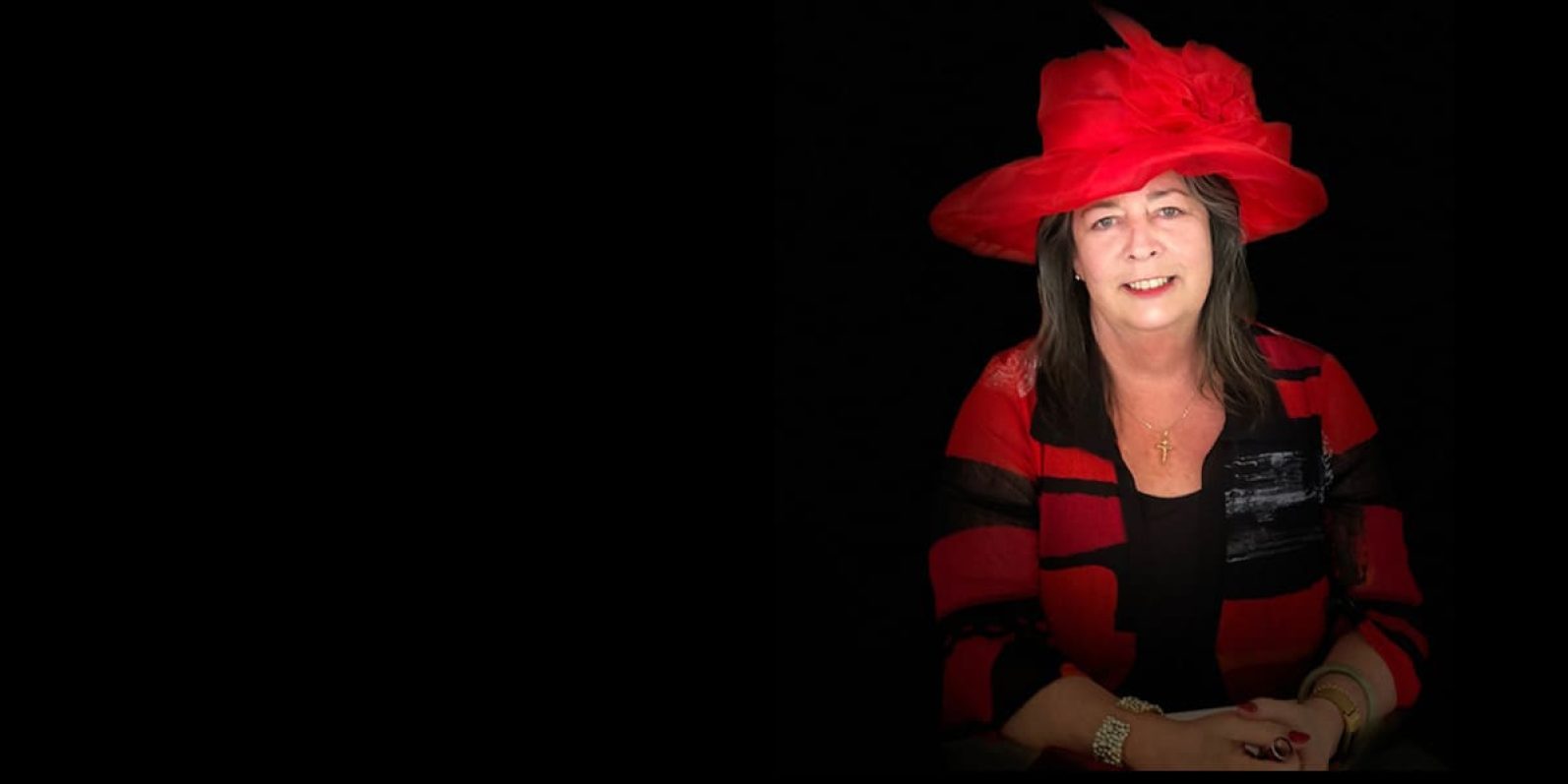 Portrait of person in black and red outfit.