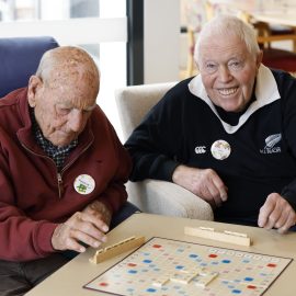 Two people playing Scrabble.