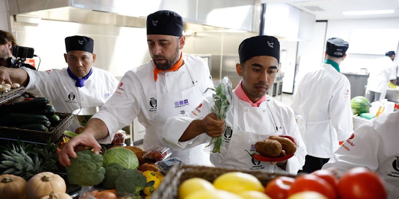 Uniting AgeWell chefs select vegetables in kitchen at Masterclass 2025.