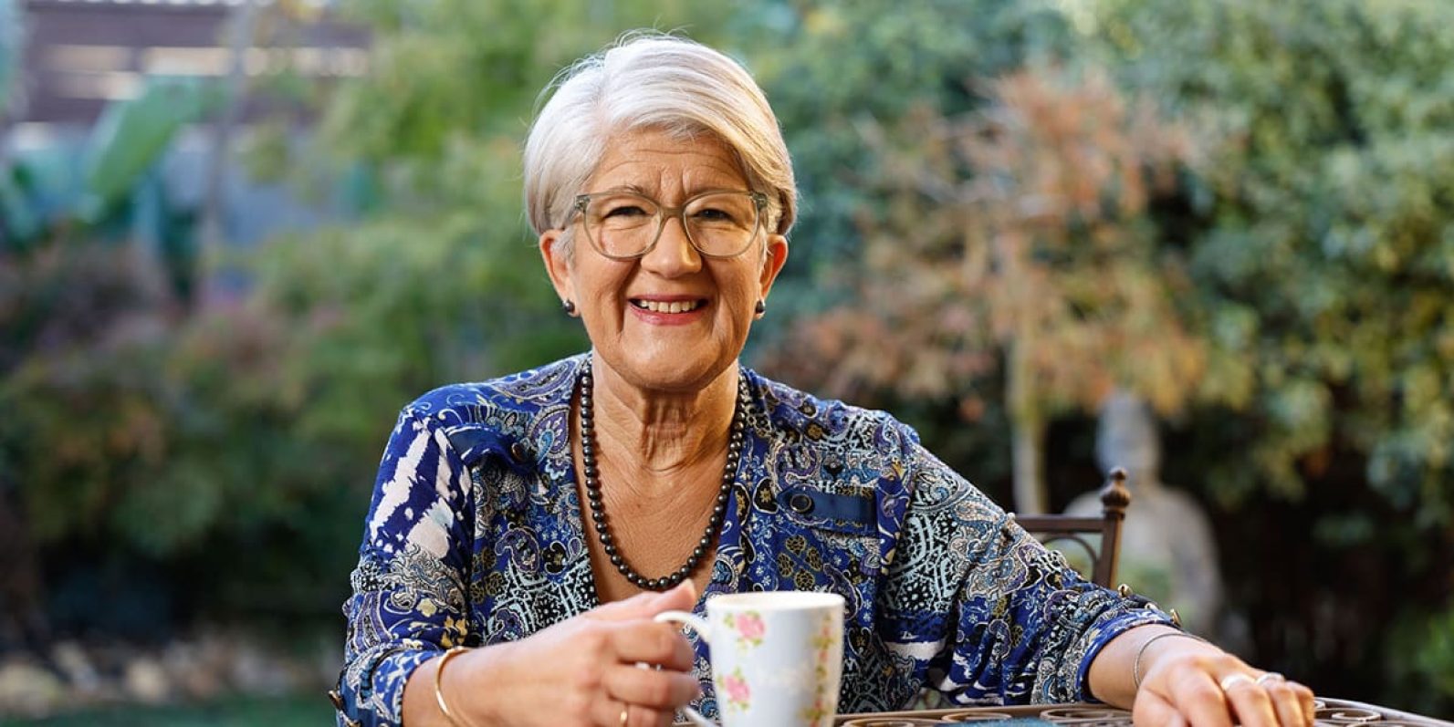 Person at table with mug of tea.