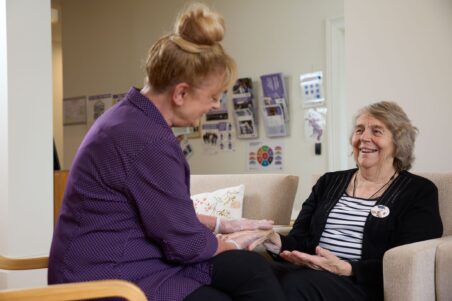 Social Connections member getting a hand massage