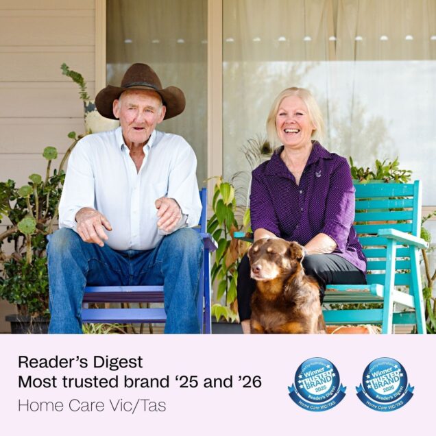 Home care customer and staff member sitting and smiling