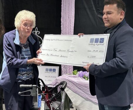 A giant cheque from Fred Hollow Foundation has been presented to a resident at Preston Community