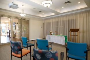 The image captures the chapel at Manor Lakes Community with seats.